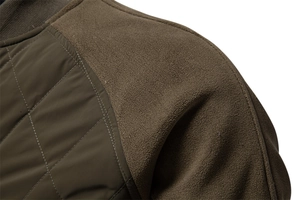 Detail of olive green jacket featuring diamond quilted fabric and fleece sleeve panels