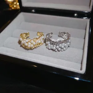 Elegant gold and silver plated open rings featuring clustered pearls and wavy metal bands