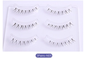 Close-up of 3 pairs of natural cross-style false eyelashes on a transparent tray, model N05