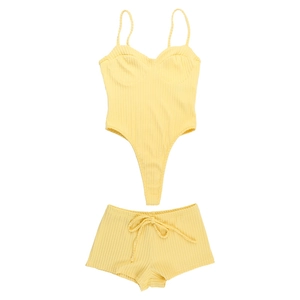 Flat lay of yellow ribbed knit two-piece set featuring camisole bodysuit and matching shorts