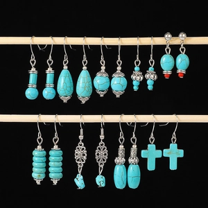 Bohemian turquoise drop earring set with vintage silver finish on black background