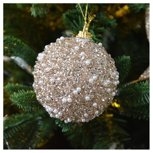 Detail of champagne gold Christmas ball with sequins and white pearls on tree branches