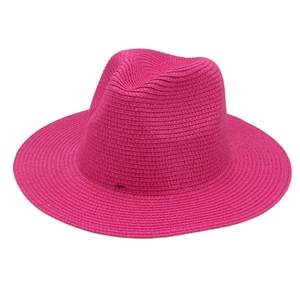 Close-up of rose red Panama straw hat showing fine herringbone weave texture and wide brim