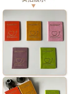 Close-up of five colorful PU leather passport covers with gold stamped heart and travel text