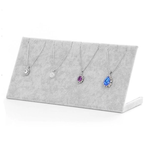 Gray velvet necklace display stand with multiple slots for jewelry collection storage