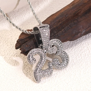 Macro detail of silver hip hop necklace with number 23 iced out pendant on twist chain