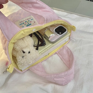Inside view of pink quilted tote bag showing spacious capacity and yellow lining