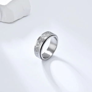 Detail of Eye of Horus spinner ring in silver stainless steel with engraved patterns