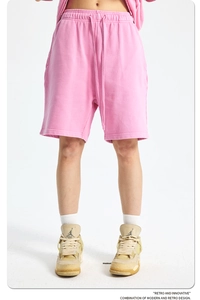 Detail view of pink cotton sweat shorts with adjustable elastic drawstring waistband