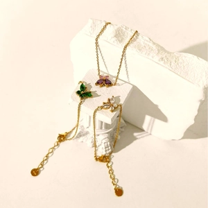 Minimalist 18K gold butterfly bracelets with colorful zircon stones on white stones