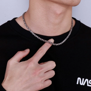 Close-up of men's stainless steel Byzantine chain necklace with silver square links