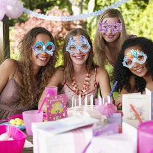 Children mermaid theme paper glasses worn by women at a colorful outdoor birthday party
