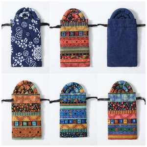Detailed set of six ethnic fabric drawstring pouches with diverse colorful patterns