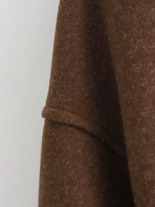 Macro shot of high-density dark brown wool fabric texture on a stand-up collar jacket