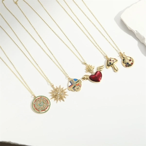 Bohemian gold plated necklace set with mushroom heart and star charms on white background