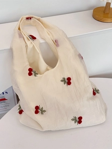 Tulle cherry embroidered canvas tote bag with wide straps in minimalist home setting
