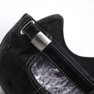 Detail of adjustable silver buckle and white contrast stitching on black washed cotton cap