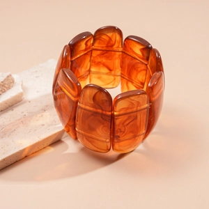 Macro shot of amber resin rectangle bracelet with vintage marble texture on stone