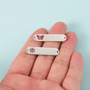 Pendentifs ovales en acier inoxydable argenté poli avec découpes papillon et flocon