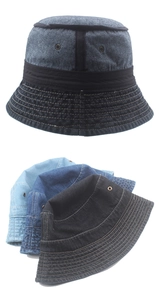 Close-up of vintage washed denim bucket hats with frayed edges and metal ventilation eyelets