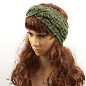 Detailed knit texture of dark green fleece-lined headband with stylish cross knot