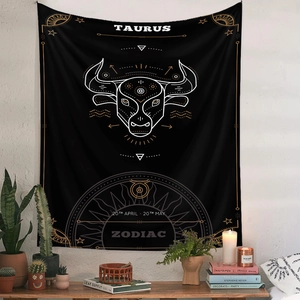 Bohemian black Taurus zodiac tapestry styled on a white wall with cozy home decor