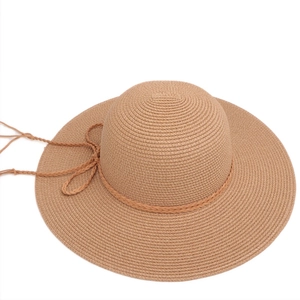 Detailed close-up of fine straw weave and braided band on a wide brim sun hat