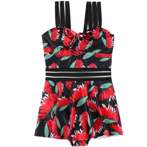 Detail of girls floral swimsuit featuring tropical leaf print and striped straps detail