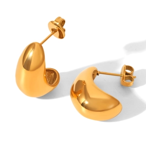Detailed view of polished 18K gold C-shaped teardrop earrings with smooth glossy finish