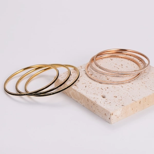 Set of 3 layered stainless steel bangles with black and white crystals in gold finish