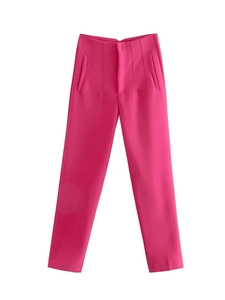 Flat lay of hot pink straight-leg trousers with structured seams and smooth suit fabric
