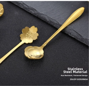 Macro shot of gold stainless steel spoons featuring cherry blossom and rose petal designs
