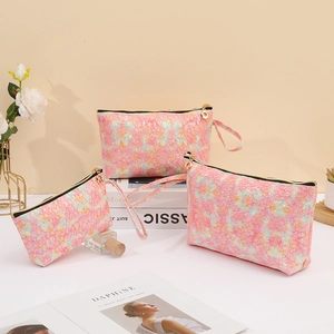Detailed set of three pink glitter lace makeup bags in various sizes for travel storage