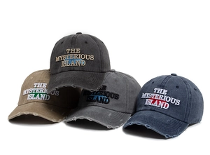 Close-up of vintage washed cotton baseball caps with distressed brim and mountain embroidery