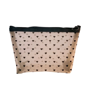 Minimalist white mesh makeup bag with black heart pattern and zipper closure