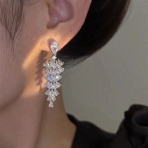 Detailed view of silver tassel earrings with cascading water-drop and marquise crystals