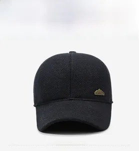 Detail of dark blue winter baseball cap featuring a metal China mountain emblem