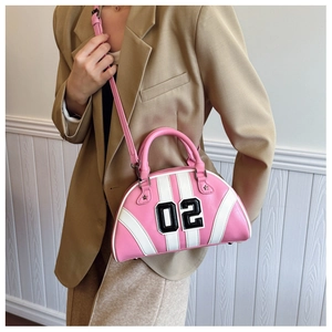 Close-up detail of stylish pink bowling handbag with contrast white stripes and 02 patch