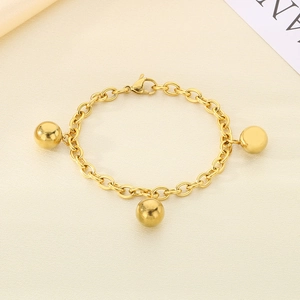Detail of 18K gold-plated titanium steel bead bracelet with lobster clasp on fabric