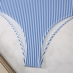 Detailed macro view of blue and white striped ribbed knit fabric with white piped edges
