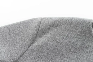 Detail shot of heavy grey woolen bomber jacket showing shoulder stitching and fabric texture