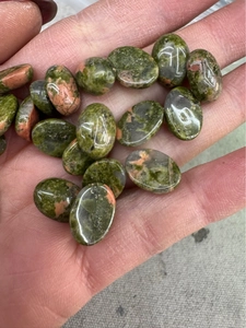Detailed view of oval natural unakite stone beads for DIY jewelry making and ring inlay