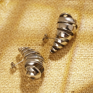 Vintage silver croissant hoop earrings with spiral design on rustic burlap background