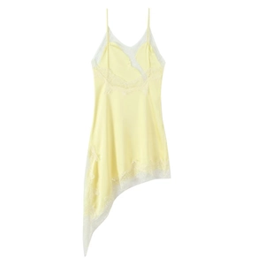 Detail view of light yellow silk dress featuring white lace trim and asymmetrical hemline
