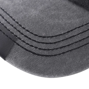 Close-up of baseball cap brim with grey washed cotton fabric and black leather piping detail