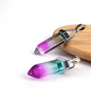 Macro shot of hexagonal crystal pendants with purple to teal gradient and silver clasps