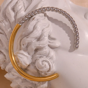 Macro detail of two-tone twisted rope bracelet on artistic white sculpture