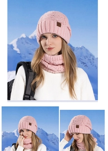 Close-up of pink knit beanie and scarf set featuring thick yarn and leather brand patch