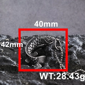 Macro shot of koi fish pendant on rock showing scale textures and 42x40mm dimensions