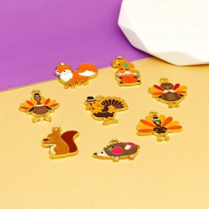 Detailed macro view of enamel Thanksgiving charms featuring turkey and squirrel designs
